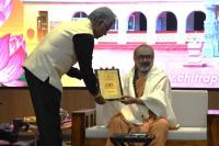Prof. BS Sahay presenting a commemorative memento to HH Swamiji